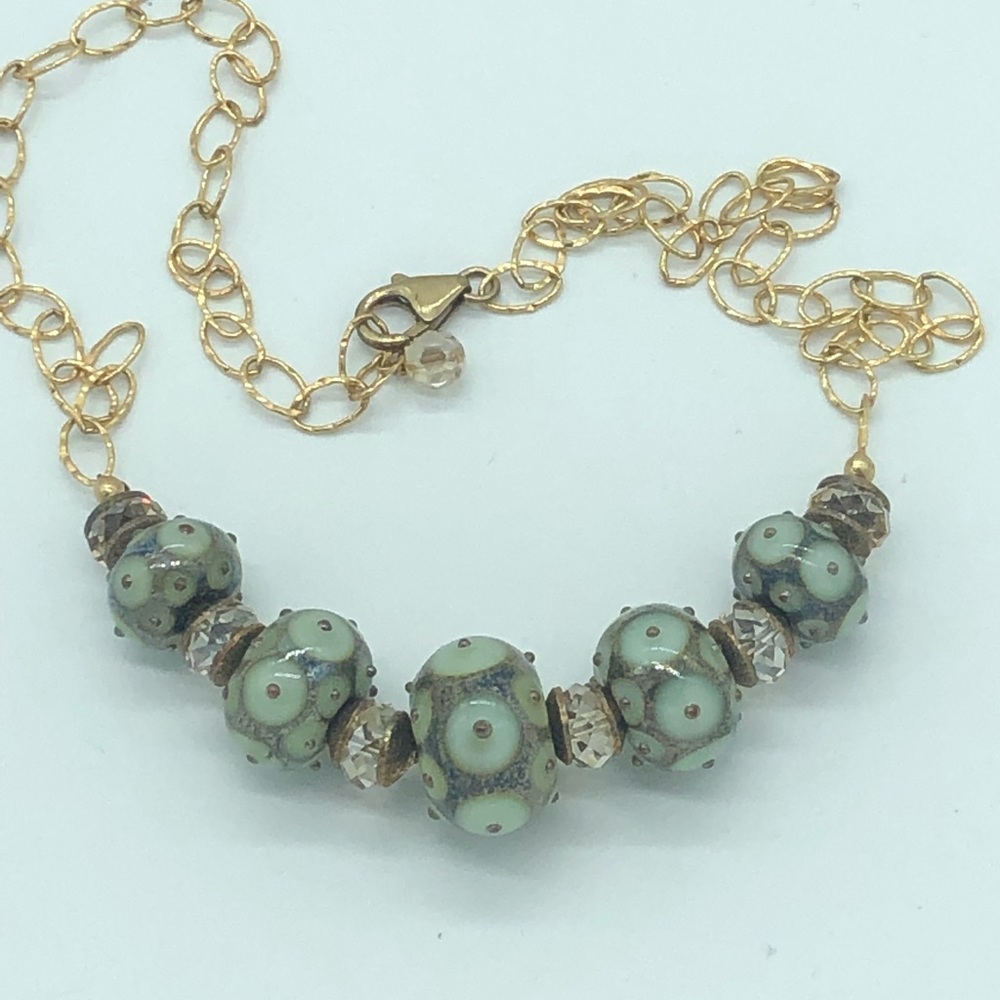 Gold tone choker necklace greenish multicolored .